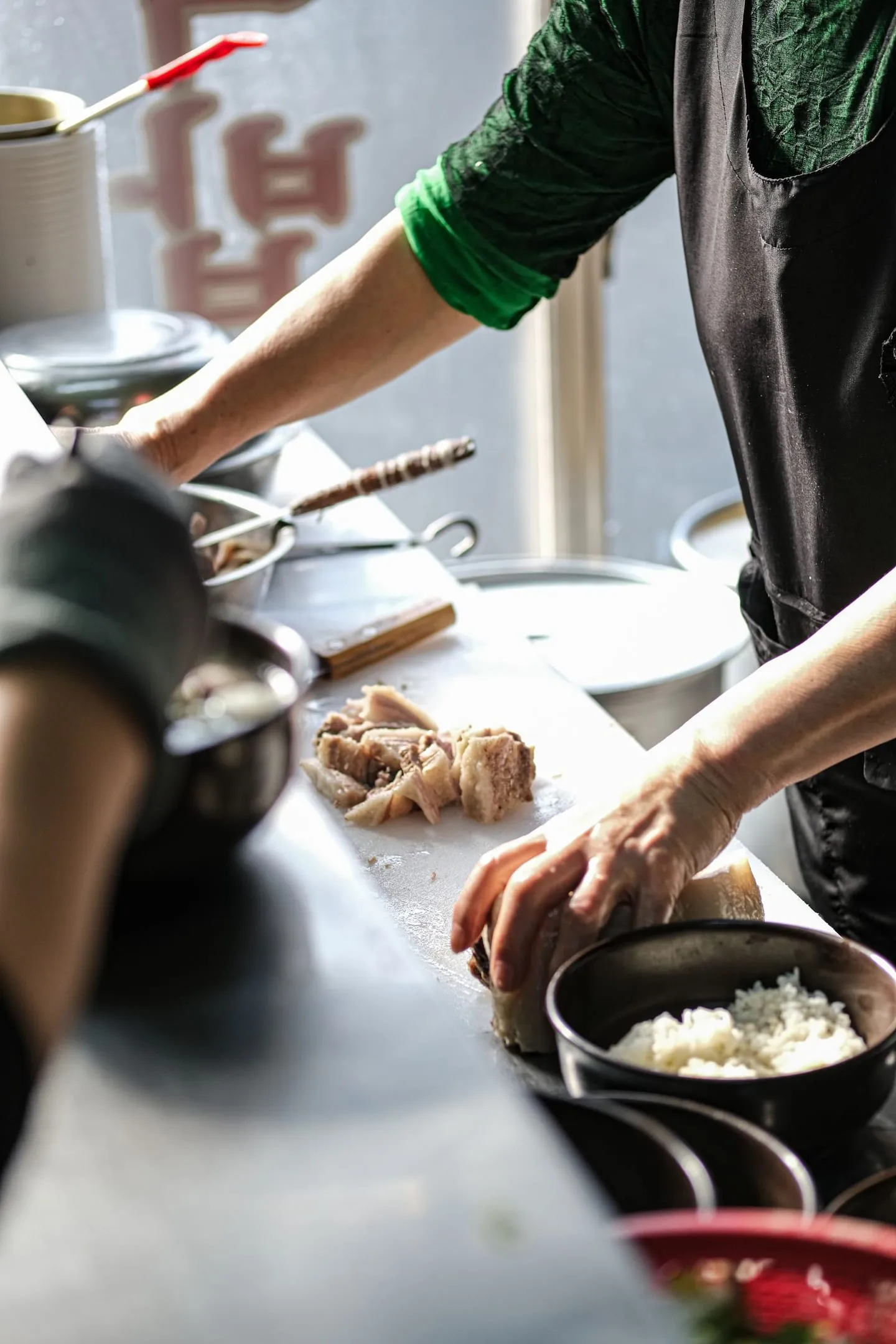 A chef chopping fresh ingredients in a restaurant kitchen