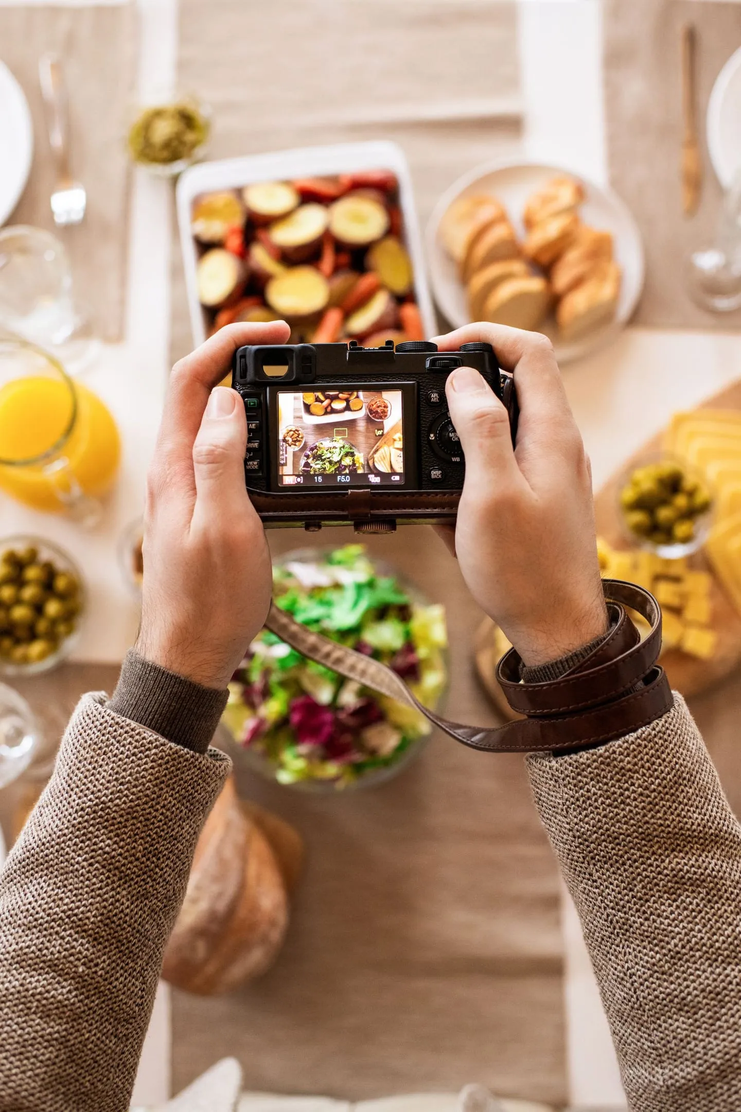 Overhead view of a photographer capturing a breakfast spread